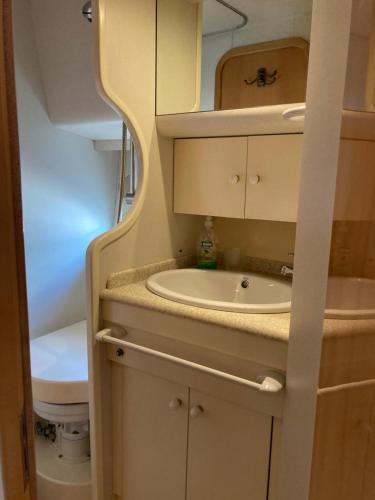 a small bathroom with a sink and a toilet at Luxury Yacht Kamikara in San Miguel de Abona