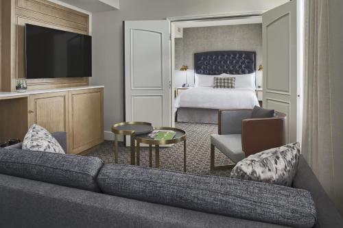 a hotel room with a couch and a bed at Hotel Teatro in Denver