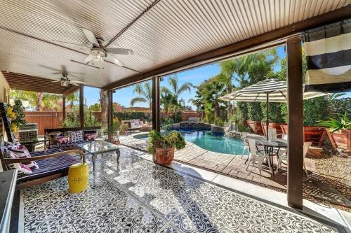 an open patio with a pool and a table at Vino Villa Large home Sleeps 10! Large Salt water pool/spa in Murrieta