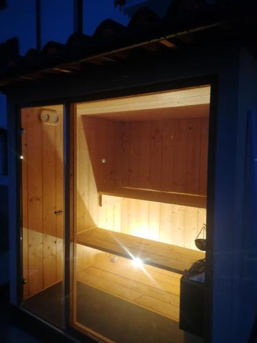 a glass window of a sauna with a light in it at Villa Belvedere Langhe in Belvedere Langhe