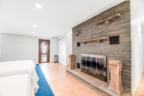 a brick fireplace in a bedroom with a bed at Live Laugh Lake - A in Rushville