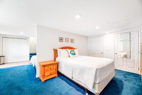 a bedroom with a white bed and a blue carpet at Live Laugh Lake - A in Rushville