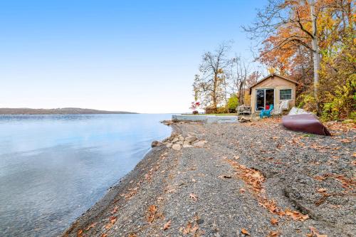 a small house on the shore of a lake at Live Laugh Lake - A in Rushville