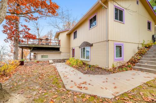 a house with a porch and a balcony at Live Laugh Lake - A in Rushville