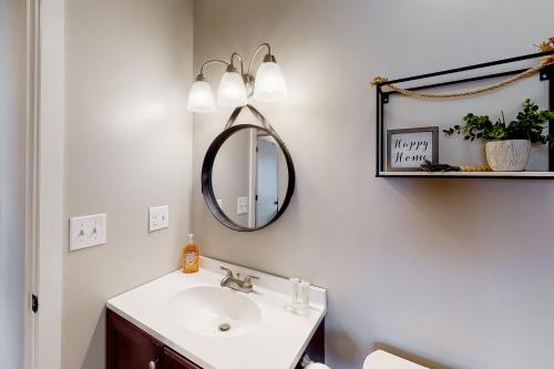 a bathroom with a sink and a mirror at Trailside 19BU & 19BL in Ludlow