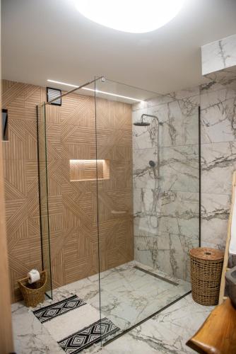 a shower with a glass door in a bathroom at Antonakis Villa Rhodes Private Pool & Jacuzzi Retreat in Kremasti
