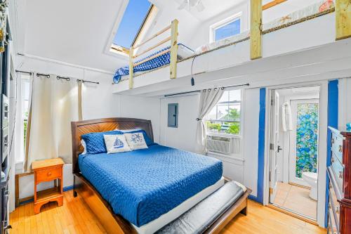 a bedroom with a bed and two bunk beds at 34 Champlain Unit 1 and Penthouse in Ocean Bay Park