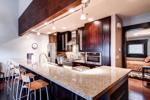 a kitchen with a large counter with stools at LAKESIDE 1629 townhouse in Park City