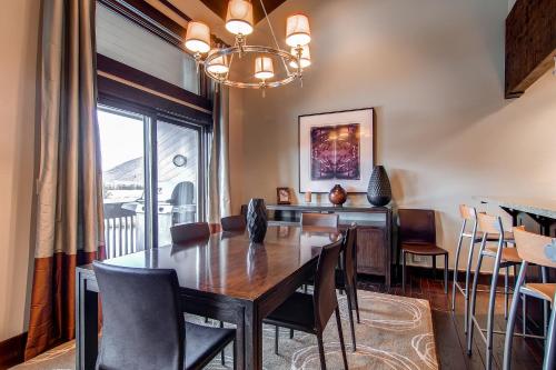 a dining room with a table and chairs and a window at LAKESIDE 1629 townhouse in Park City