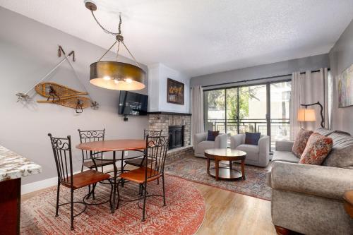 a living room with a table and a couch at EDELWEISS HAUS 117 condo in Park City