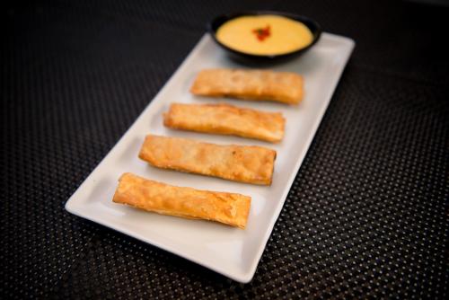 a white plate with three pieces of food on it at Hotel Boutique Runcu Miraflores in Lima
