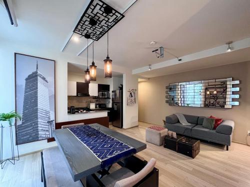 a living room with a couch and a table in it at Mi Zona Lodging Xochicalco in Mexico City