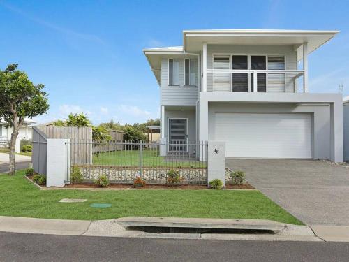 a large white house with a garage at The White House Yamba in Yamba