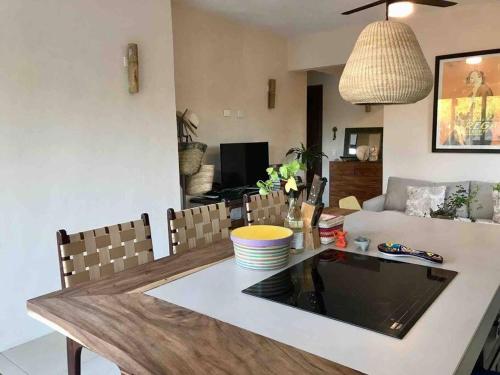 a living room with a table and a couch at CasaCalma Great for families! in Holbox Island