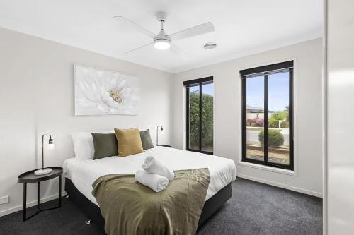a bedroom with a large white bed and a window at Chifley Place - Cool Suburban Crib! in Sebastopol