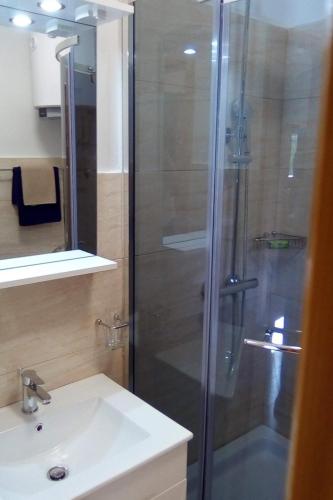 a bathroom with a glass shower and a sink at Apartments by the sea Valun, Cres - 386 in Valun
