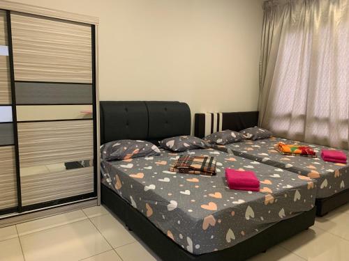 a bedroom with a bed with pillows on it at Woodsbury Suites 7722 Butterworth Penang in Butterworth