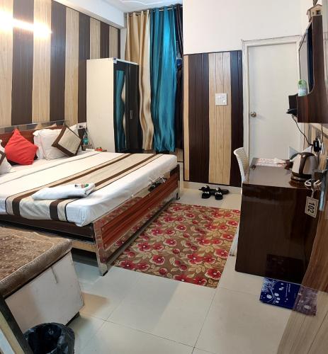 a bedroom with a bed and a table and a desk at Greno House in Greater Noida