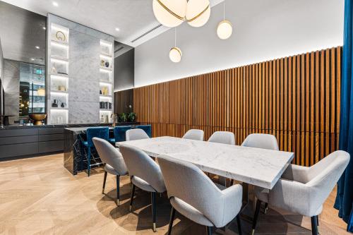 a dining room with a table and chairs at Paragon Apartments by CLLIX in Melbourne