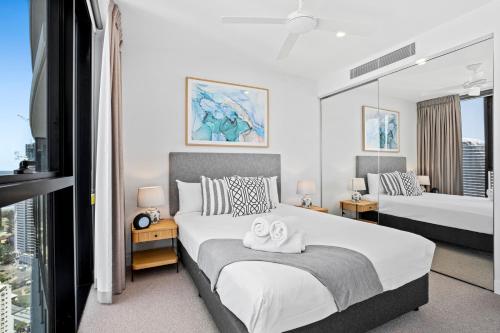 a bedroom with two towels on a bed at Broadbeach Casino Private Apartments - gclr in Gold Coast