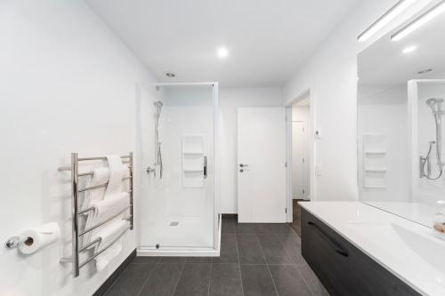a white bathroom with a sink and a shower at Blue Dun Views - Taupo in Taupo