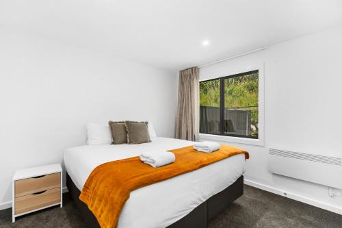 a bedroom with a large bed and a window at Blue Dun Views - Taupo in Taupo