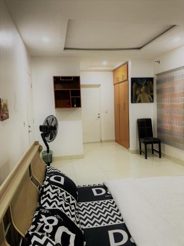 a room with a bed and a fan in it at Entire Serviced Two bedroom duplex Abuja - 24hr WIFI, POWER, OFFICE, FULL KITCHEN in Abuja