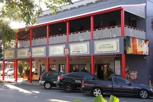 a black truck parked in front of a building at The Jack Backpackers in Cairns