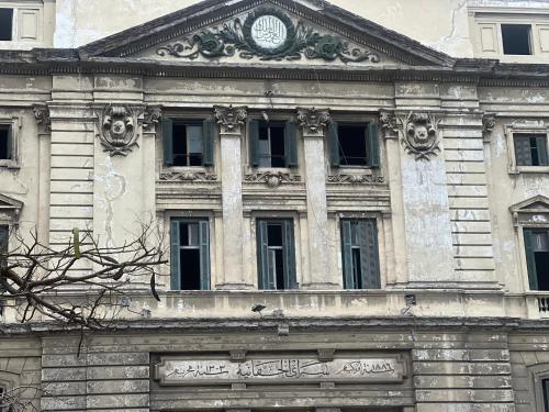 a building with a clock on top of it at Private Room In Apartment with Sea & Hilton View in Alexandria