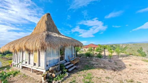 a small hut with a thatched roof at Hars Garden Sumba in Waingapu
