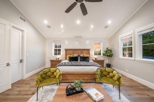 a bedroom with a bed and two yellow chairs at Luxury Woodbrigde -8 Bedroom in Los Angeles