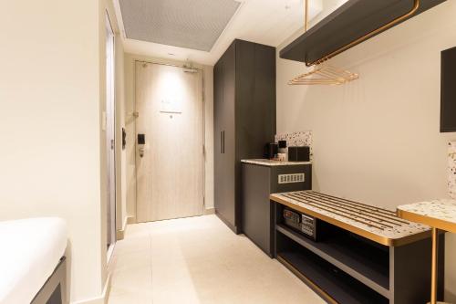 a small kitchen with a bench and a door at ibis budget Singapore Gold in Singapore