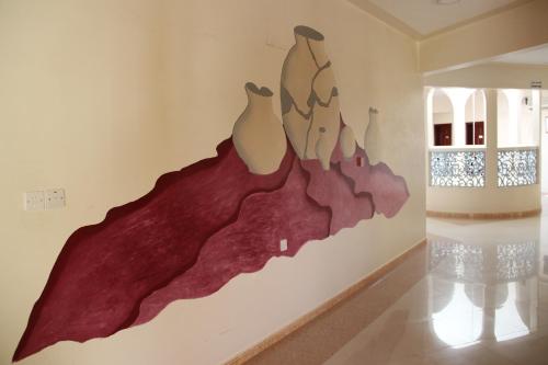 a painting on a wall in a room at Al Diyar Hotel in Nizwa