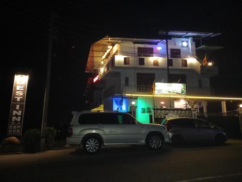 two cars parked in front of a building at night at Lucky Star View Inn in Bandarawela