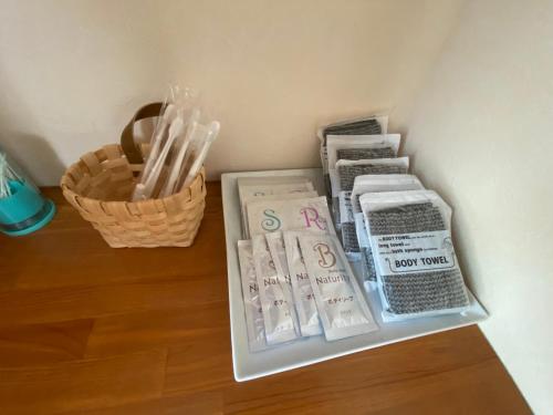 a shelf with books and a basket of toothbrushes at BAYMARINAログハウス in Sakaide