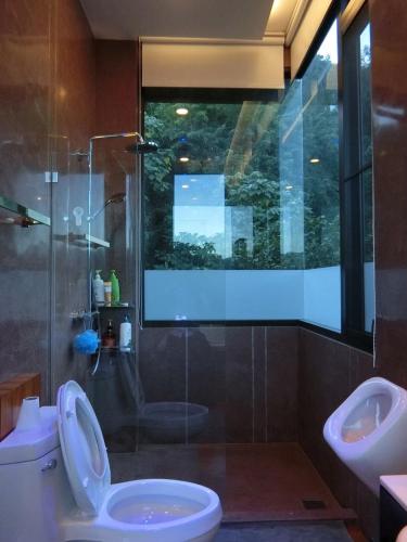 a bathroom with a toilet and a sink and a shower at The Height Khaoyai Resort in Ban Huai Sok Noi