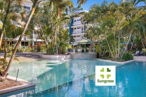 a swimming pool with a sign in front of a resort at Azzura Greens Resort in Gold Coast
