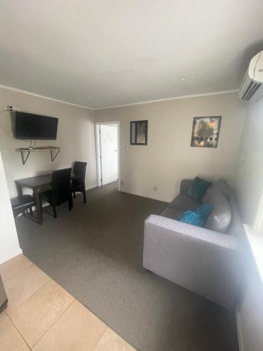a living room with a couch and a table at Springfield Motel and Lodge in Springfield