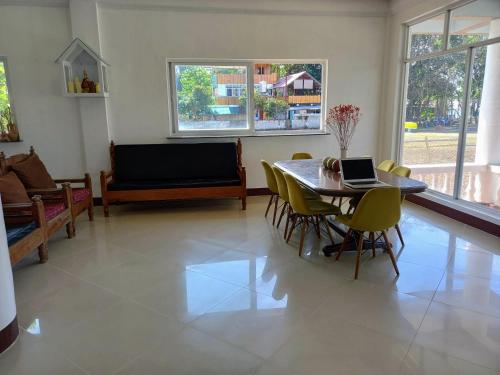 a living room with a table with a laptop on it at Seven Waves Beachfront Residence 