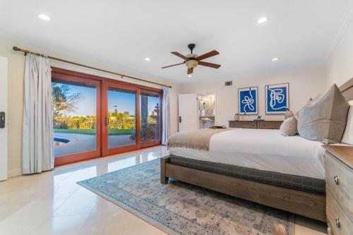 a bedroom with a large bed and a large window at 5bdr park lane villa-basketball court-pool-views in Los Angeles