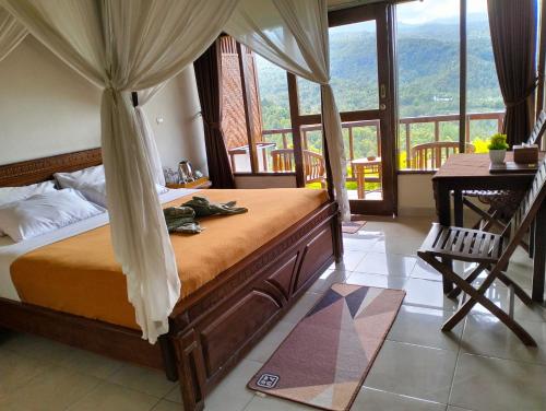 a bedroom with a bed and a desk and windows at Made Oka Homestay and Warung in Munduk