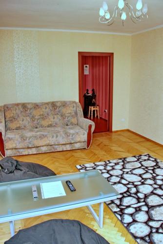 a living room with a couch and a table at Topol Apartment in Dnipro
