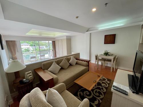 a living room with a couch and a table at Kantary Bay Hotel Phuket in Panwa Beach