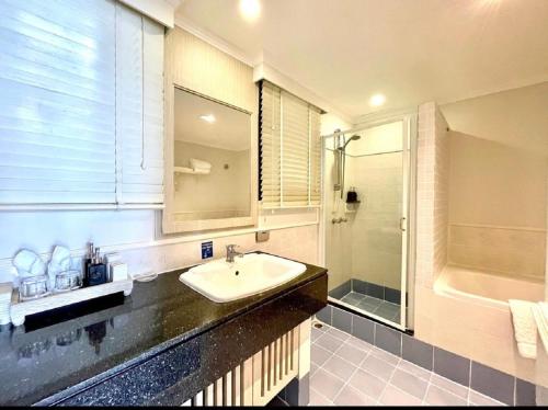 a bathroom with a sink and a shower at Kantary Bay Hotel Phuket in Panwa Beach