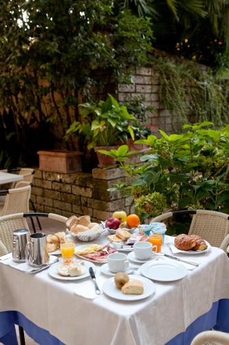 a table with breakfast foods and drinks on it at Hotel Idania in Bardolino