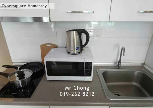 a microwave sitting on top of a kitchen counter at Cybersqaure Studio Suites with Wifi in Cyberjaya