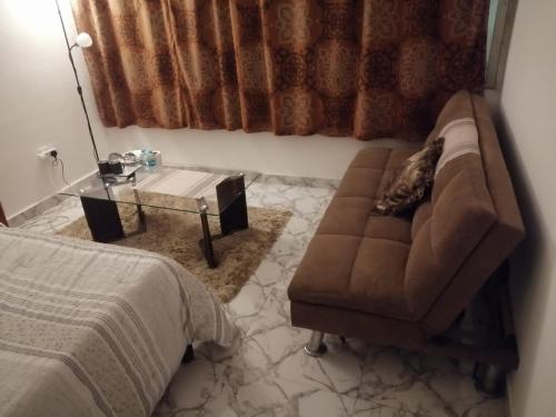 a living room with a couch and a table at Tanih Place in Abu Dhabi