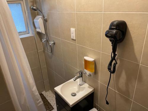 a bathroom with a phone on the wall next to a sink at bnb2night Polanco-Metro in Mexico City