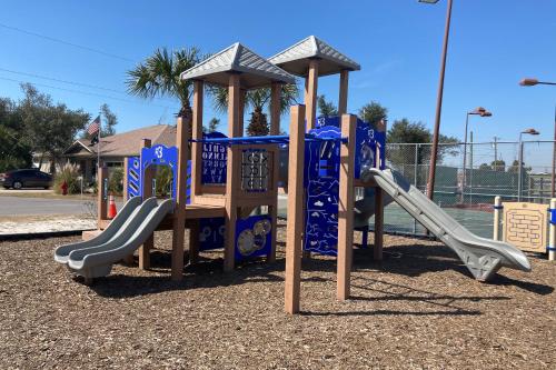 a playground with slides in a park at Isle of View Always in Mexico Beach