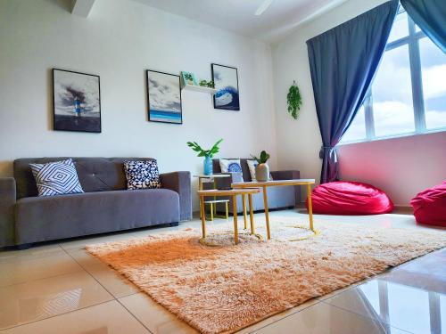 a living room with a couch and a table at KLIA Nilai Sepang EHSAN RESIDENCE 8 PAX Air-Con Homestay in Sepang